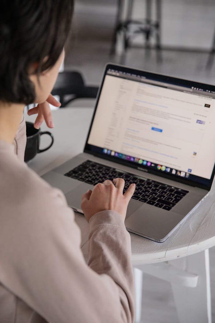 crop unrecognizable businesswoman typing on laptop at home 4050216